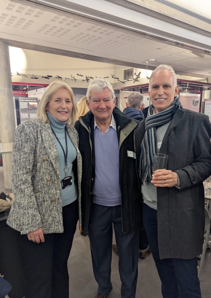 Group of attendees posing together at an indoor networking event