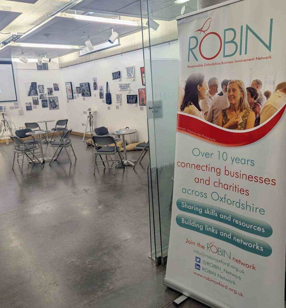 Exhibition stand with a pink ROBIN pull-up banner in a venue lobby