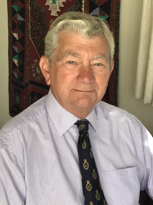 Ian Inshaw DL Portrait of a man wearing a white shirt and dark tie