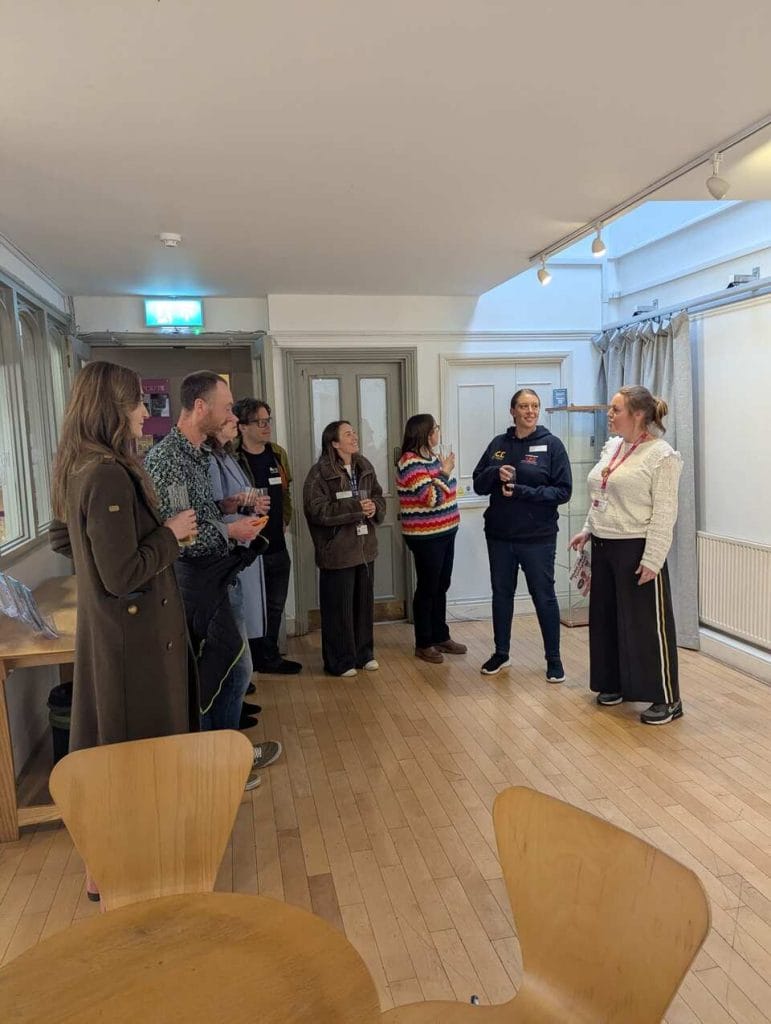 Attendees mingling in a venue corridor during a networking event